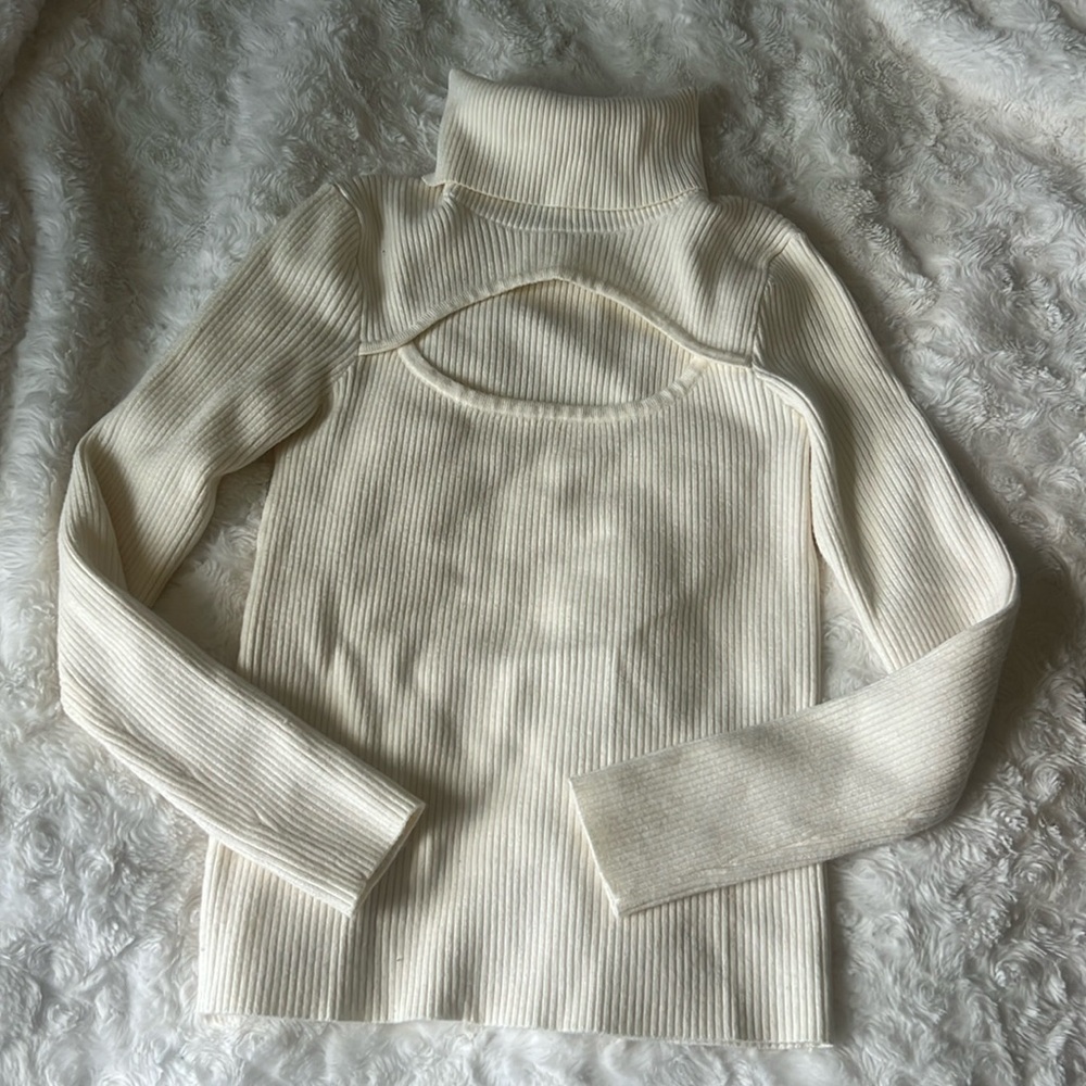 Cream turtleneck sweater with keyhole cutout